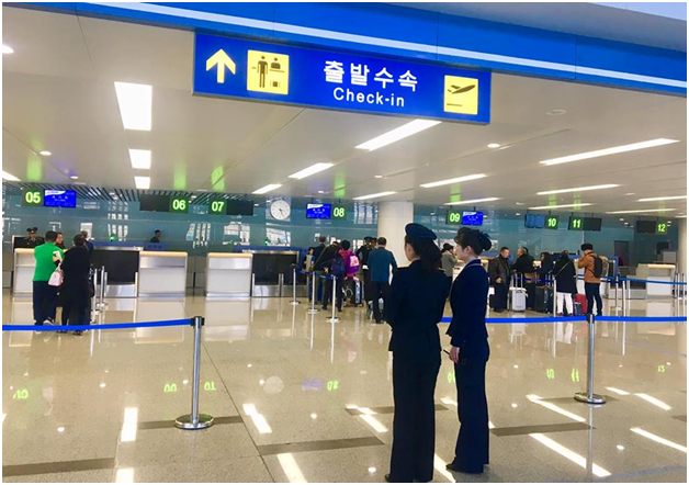 Hai nhân viên sân bay tại khu vực quầy check - in ga quốc tế. Nhà ga này là tổ hợp gồm 12 quầy thủ tục, các cửa hàng thời trang, quà lưu niệm, khu mua sắm miễn thuế và nhà hàng. Các mặt hàng ở Triều Tiên có giá gần như là bằng nhau tại mọi địa điểm, kể cả sân bay. Ảnh: Lê Vân