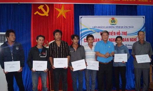 Ông Trần Văn Thanh - Chủ tịch LĐLĐ tỉnh Quảng Ngãi trao tiền hỗ trợ cho các ngư dân. TD