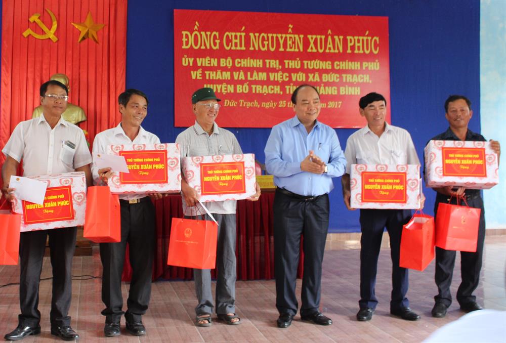 Thủ tướng Chính phủ Nguyễn Xuân Phúc tặng quà cho người dân xã Đức Trạch (huyện Bố Trạch). Ảnh: Lê Phi Long