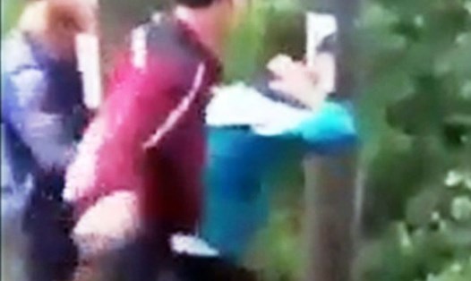 Hình ảnh thiếu niên mặc đồng phục học sinh bị đánh (ảnh cắt từ clip)
