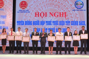 Ông Nguyễn Quốc Hùng, Phó chủ tịch UBND tỉnh Đồng Nai trao bằng khen cho đại diện Nestlé Việt Nam cùng đại diện các doanh nghiệp, cá nhân khác.
