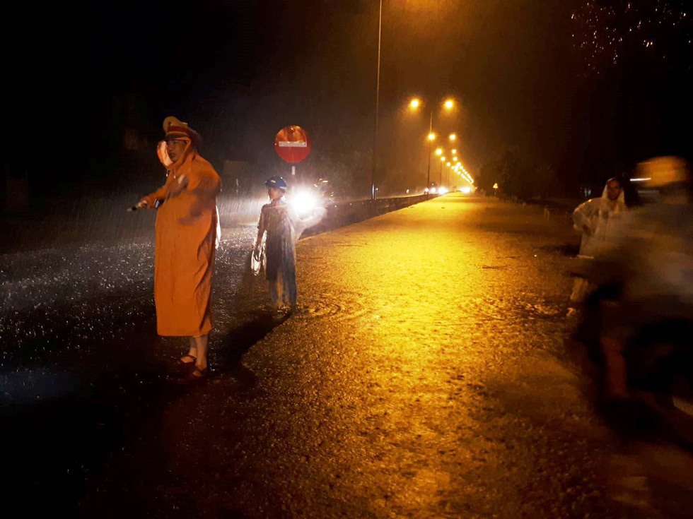 Lực lượng CSGT túc trực trong đêm mưa lũ để phân luồng giao thông. Ảnh: Đ.V