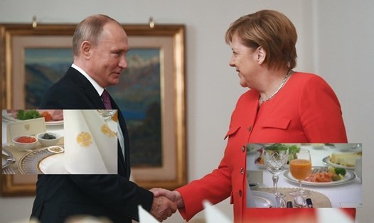 Tổng thống Nga Vladimir Putin bắt tay Thủ tướng Đức Angela Merkel tại G20. Ảnh: RT