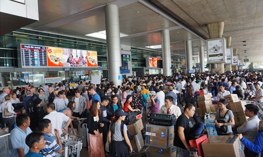 Sảnh ga quốc tế sân bay Tân Sơn Nhất đông nghịt người đến đón Việt kiều về nước ăn tết.  Ảnh: Minh Quân