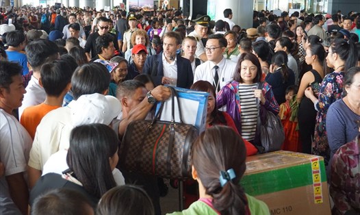 Sảnh ga quốc tế sân bay Tân Sơn Nhất chật kín lượng người đến đón người thân về nước ăn tết. Ảnh: MINH QUÂN