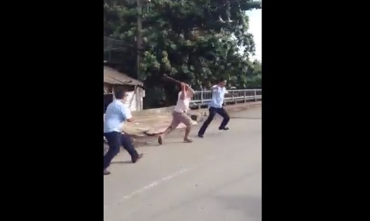 Ông Quốc dùng búa đánh ông Nguyễn Quang Vinh. (Ảnh cắt từ clip)