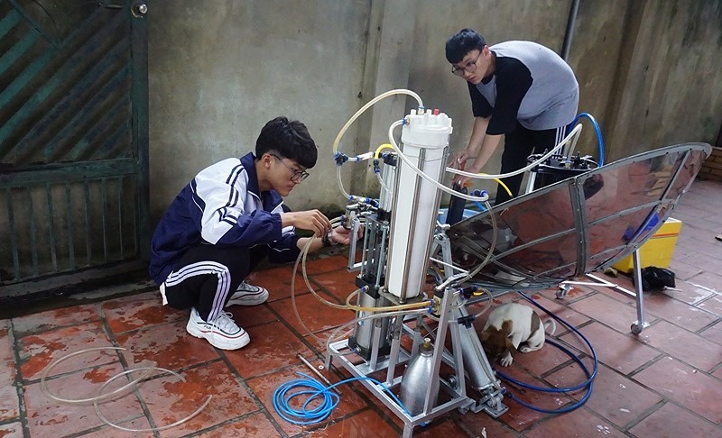 Em Nhật Anh (trái) và Văn Long đang kiểm tra dự án thiết bị "hô biến" nước mặn thành nước ngọt bằng năng lượng sóng biển. Ảnh: NA