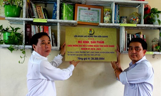 Ông Trần Thanh Việt (trái) trực tiếp gắn biển Công trình "Góc thư viện lớp học". (Ảnh: Thanh Bách)