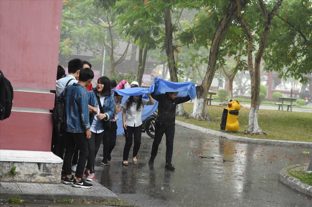 Trong ngày làm thủ tục hôm 24.6, cơn mưa lớn đã gây khó khăn cho các sĩ tử. Ảnh: NĐT