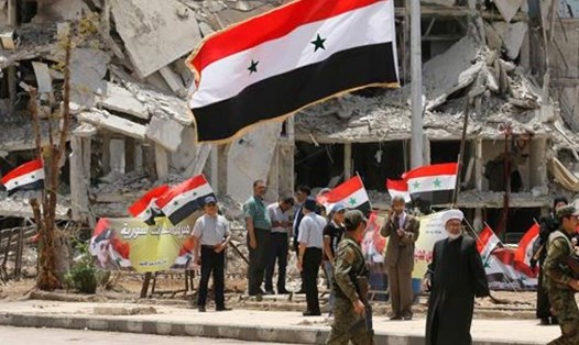 Quốc kỳ Syria ở Deraa. Ảnh: AFP