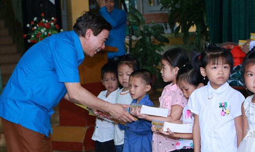 Chủ tịch LĐLĐ tỉnh Hoà Bình Bùi Tiến Lực tặng quà cho các em học sinh.