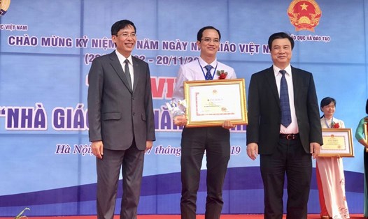 Thứ trưởng Bộ Giáo dục Đào tạo Nguyễn Hữu Độ (ngoài cùng, bên phải) và Chủ tịch Công đoàn Giáo dục Việt Nam Vũ Minh Đức (ngoài cùng, bên trái) trao bằng khen cho nhà giáo tiêu biểu. Ảnh: LAN DỊU