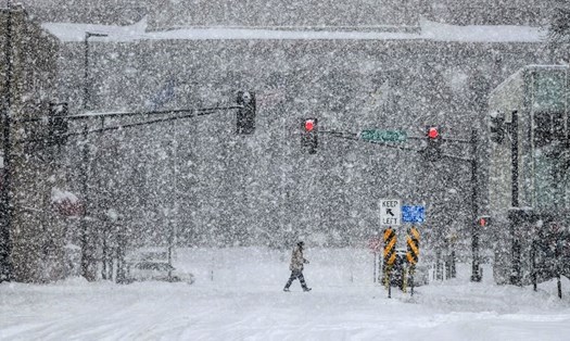  Một người đi bộ băng qua đường trong cơn mưa tuyết sáng 20.2.