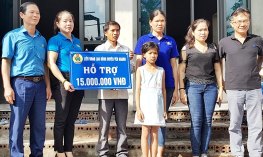 Đại diện lãnh đạo LĐLĐ huyện Yên Khánh trao tiền hỗ trợ cho gia đình chị Lan. Ảnh: NT
