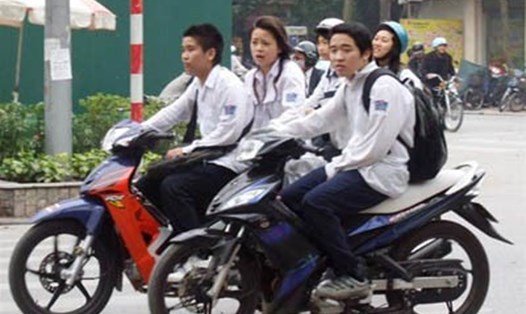 Tình trạng học sinh đi xe máy đến trường không đội mũ bảo hiểm vẫn gia tăng.