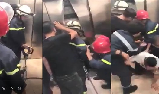 Lực lượng cứu hộ phá cửa thang máy giải cứu nạn nhân. Ảnh căt từ clip công an cung cấp.