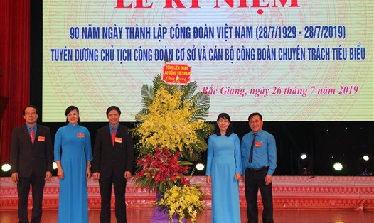 Đồng chí Trịnh Thanh Hằng, Ủy viên Đoàn Chủ tịch, Trưởng ban Nữ công (Tổng Liên đoàn Lao động Việt Nam) trao lẵng hoa chúc mừng của Tổng Liên đoàn Lao động Việt Nam tới Liên đoàn Lao động tỉnh Bắc Giang.