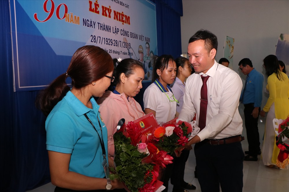 Ông Nguyễn Đình Khánh, Phó Chủ tịch LĐLĐ tỉnh Bình Dương tặng hoa các đoàn viên khó khăn được tặng sổ tiết kiệm.