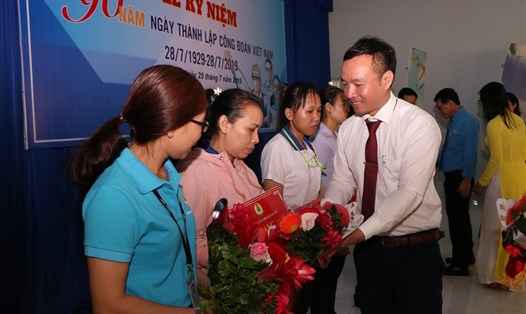 Ông Nguyễn Đình Khánh, Phó Chủ tịch LĐLĐ tỉnh Bình Dương tặng hoa các đoàn viên khó khăn được tặng sổ tiết kiệm.
