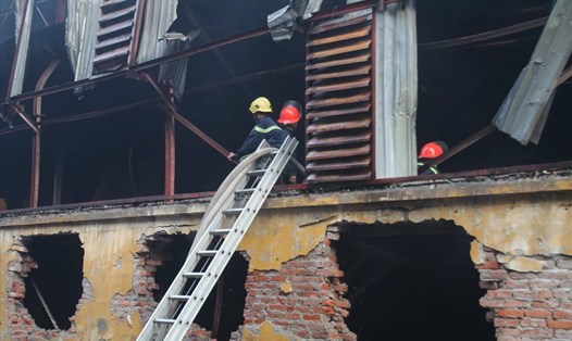Hơn 14 giờ liên tục cứu hỏa nhưng hiện tại, khu vực nhà xưởng của Công ty bóng đèn phích nước Rạng Đông vẫn âm ỉ cháy. Ảnh: Hà Vy