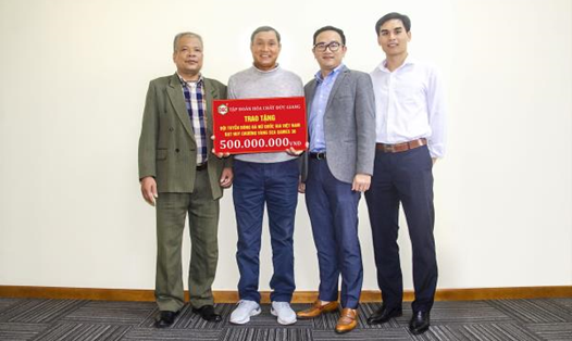 Đại diện Công ty Đức Giang trao bảng tiền thưởng tượng trưng cho ông Mai Đức Chung tại VFF. Ảnh: TL