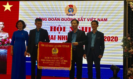 Phó chủ tịch Tổng Liên đoàn Lao động Việt Nam Trần Văn Thuật (trái) trao tặng Cờ thi đua cho Công đoàn Đường sắt Việt Nam. Ảnh: T.E.A