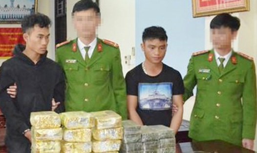 Hai đối tượng người Lào (áo đen) bị bắt giữ cùng tang vật. Ảnh NTV