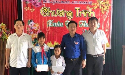 Lãnh đạo Sở Nội vụ tỉnh Quảng Trị trao quà cho 2 học sinh có hoàn cảnh khó khăn. Ảnh: TT.