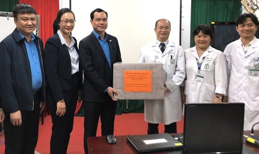 Trong đêm 30 Tết, Chủ tịch Tổng LĐLĐVN Nguyễn Đình Khang (thứ 4 từ trái sang) tặng quà tập thể bác sĩ, nhân viên y tế Trung tâm Bệnh nhiệt đới. Ảnh: V.L
