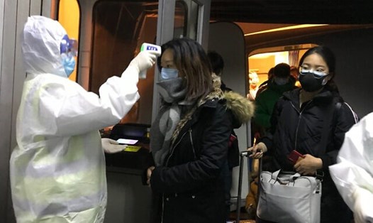 Hành khách được kiểm tra thân nhiệt tại sân bay ở Bắc Kinh. Ảnh: AP.