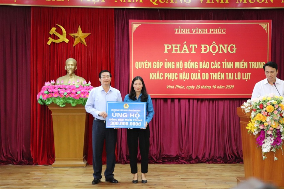 Bà Trịnh Thị Thoa – Chủ tịch Liên đoàn Lao động tỉnh Vĩnh Phúc - trao tiền ủng hộ đồng bào các tỉnh miền Trung khắc phục hậu quả thiên tai lũ lụt qua Uỷ ban Mặt trận Tổ quốc Việt Nam tỉnh Vĩnh Phúc. Ảnh: Lâm Nguyễn.