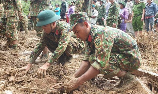 Các chiến sĩ dùng tay đào đất tìm kiếm nạn nhân bị mất tích ở thôn 1, xã Trà Leng. Ảnh: Thanh Chung