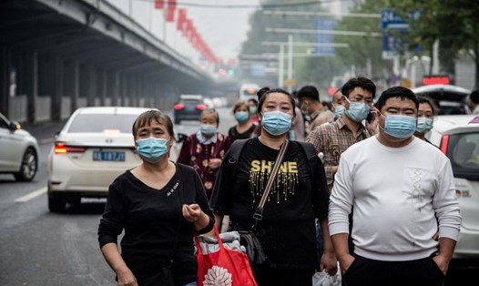Người dân Trung Quốc đi bộ trên đường phố Vũ Hán tháng 9.2020. Vũ Hán là nơi đầu tiên phát hiện các ca COVID-19. Ảnh: AFP.