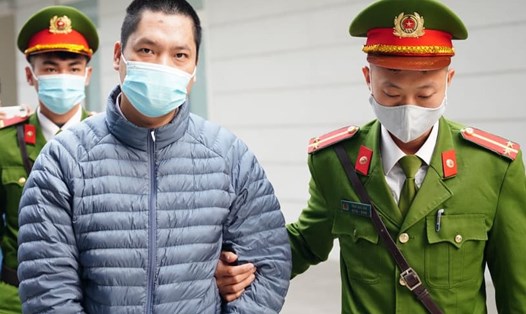Bị cáo Nguyễn Trần Duy (bên trái, áo khoác) trong vụ án sai phạm xảy ra tại CDC Hà Nội. Ảnh: V.Dũng.