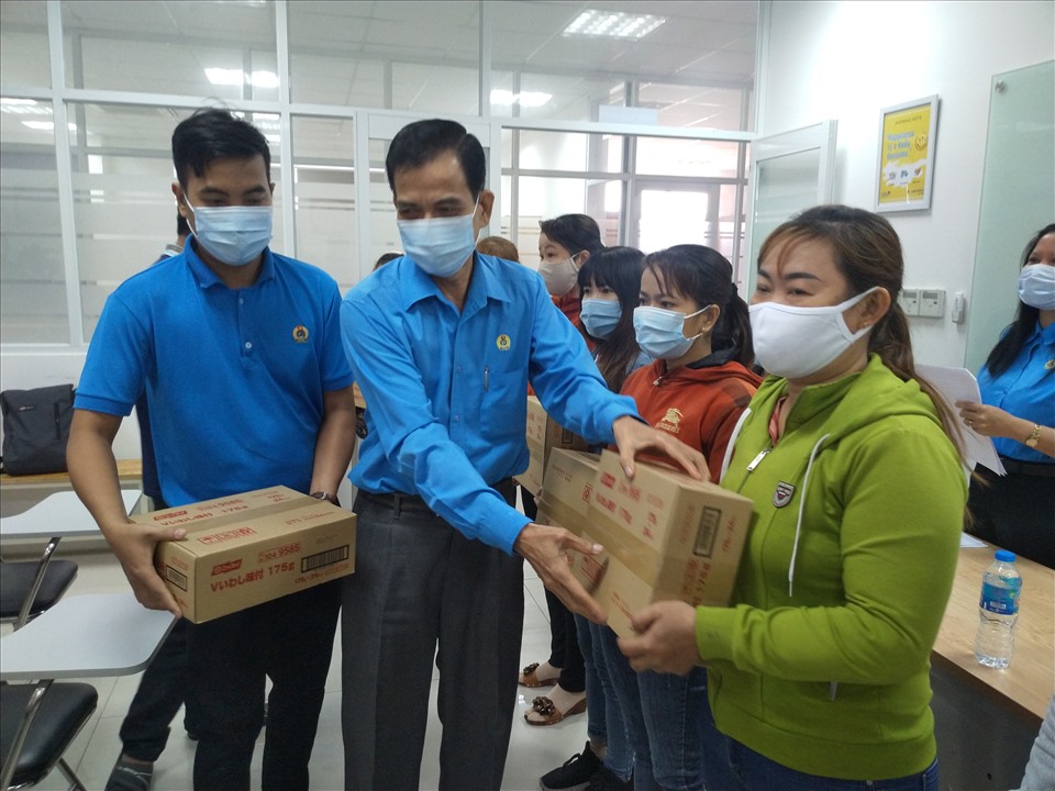 Chủ tịch LĐLĐ tỉnh Tiền Giang - ông Trương Văn Hiền - trao quà cho CNLĐ gặp khó khăn do dịch bệnh Covid-19. Ảnh: K.Q