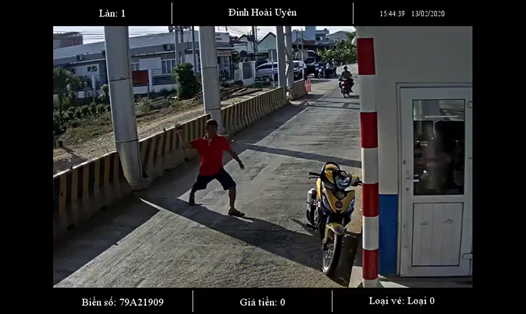 Đối tượng lạ mặt đang ném đá vào nhân viên thu phí tại BOT Ninh Xuân. Ảnh: Cắt từ clip