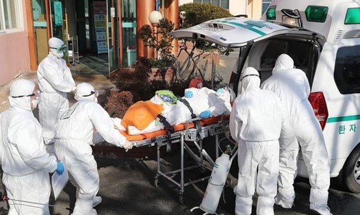Di chuyển một bệnh nhân nghi nhiễm COVID-19 từ bệnh viện Daenam ở Cheongdo hôm 21.2. Ảnh: AFP