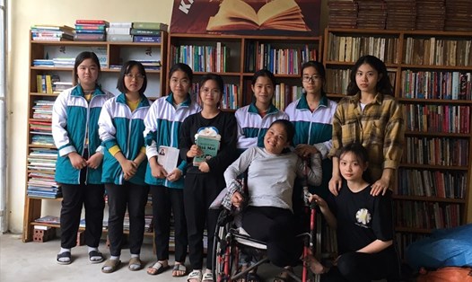 Nguyễn Lan Hương (người ngồi xe lăn) cùng các bạn nhỏ đến đọc sách tại thư viện. Ảnh: PV