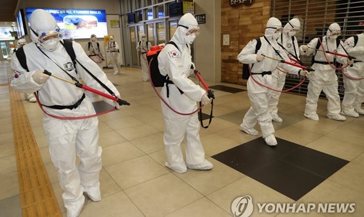 Cơ quan y tế quân đội Hàn Quốc đang khử trùng tại một nhà ga ở thành phố Daegu ngày 29.2. Ảnh: Yonhap