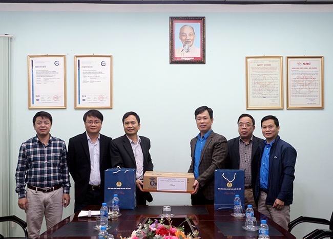 Đồng chí Nguyễn Huy Thông - Chủ tịch Công đoàn Công nghiệp Hoá chất Việt Nam (thứ ba từ phải sang) tặng nước diệt khuẩn cho đại diện Công ty caosu Sao Vàng. Ảnh: H.C