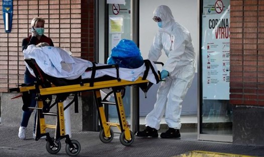 Một nhân viên y tế chuyển một bệnh nhân lên cáng tại bệnh viện Severo Ochoa ở Leganes, Tây Ban Nha. Ảnh: AFP.