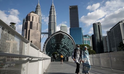 Hai phụ nữ di chuyển ở thủ đô Kuala Lumpur, Malaysia. Ảnh: Reuters.