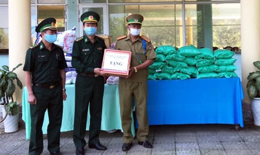 Đại tá Nguyễn Xuân Hoà - Chỉ huy trưởng BĐBP Thừa Thiên Huế (đứng giữa) trao tặng vật tư y tế và nhu yếu phẩm cho lực lượng chức năng Lào. Ảnh: Võ Tiến.