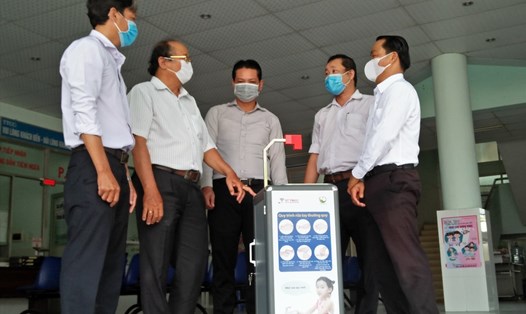 TS Nguyễn Văn Hiếu (phải) trao tặng máy rửa tay diệt khuẩn thông minh cho Trung tâm Y tế quận 9. Ảnh: MK