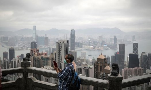 Một người đàn ông đeo khẩu trang đang đứng trên núi The Peak, Hong Kong. Ảnh: China Daily
