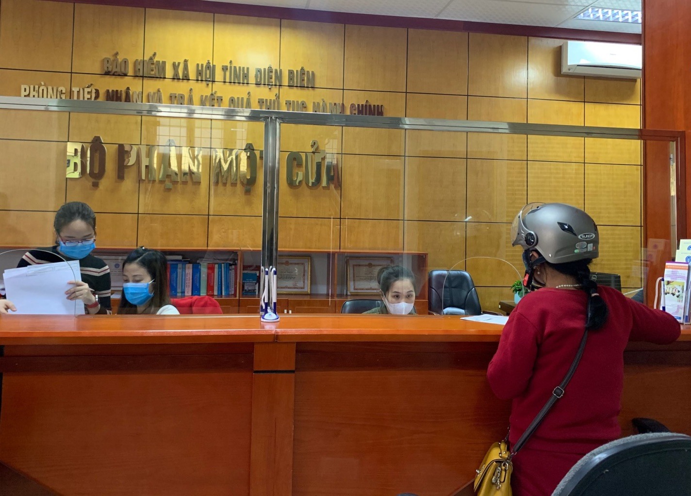Cán bộ BHXH tỉnh Điện Biên hướng dẫn người lao động thực hiện hồ sơ BHXH. Ảnh: Ngọc Ánh