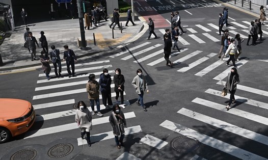 Người dân Hàn Quốc đi bộ trên đường phố Seoul hôm 23.4. Ảnh: AFP.