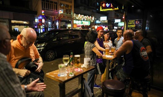 Khách hàng đang ngồi tại một quán bar ở Hong Kong. Ảnh: Reuters