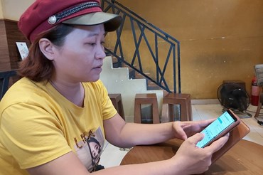 Chị Thái Thị Bích Thảo đang kiểm tra việc gia hẹn thẻ BHYT của mình, Ảnh Nam Dương