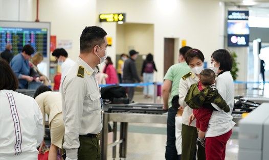 Lực lượng an ninh hàng không kiểm soát thân nhiệt hành khách tại sân bay Nội Bài. Ảnh ĐT